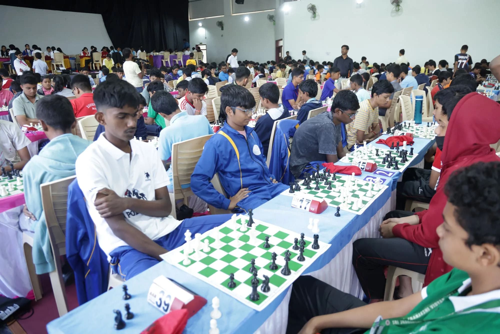 Rows of boards and clocks in play in the school hall — CBSE South Zone-II Chess Championship, 2025.