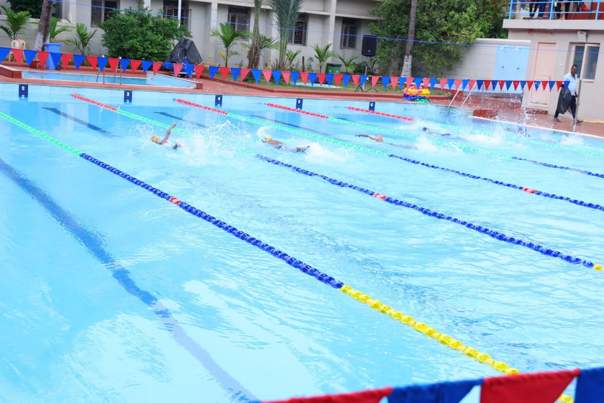 A heat under way across the six-lane campus pool — CBSE South Zone Swimming Championship, 2024.