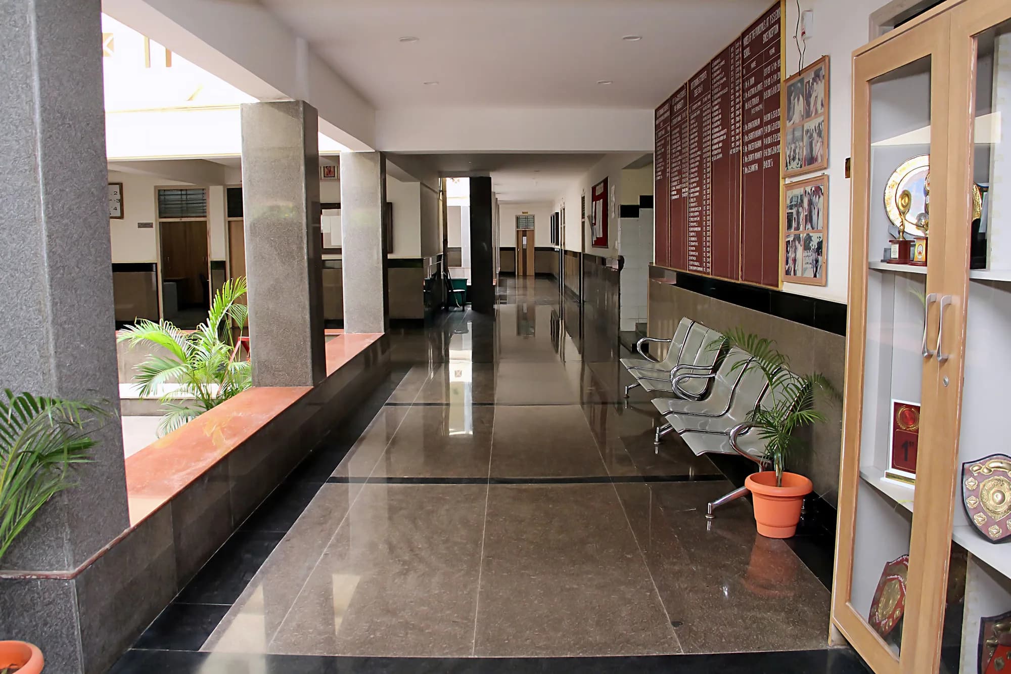 Corridor at PSSEMR School with an honours board of past principals and a cabinet of shields