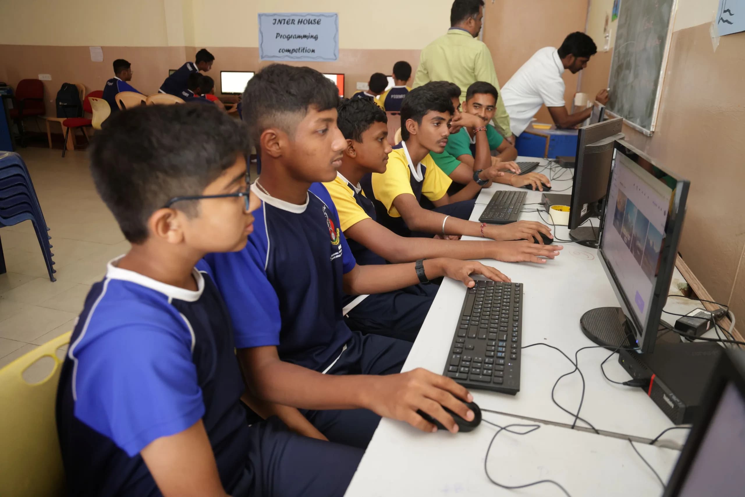 Students at monitors during an inter-house programming round at PSSEMR School