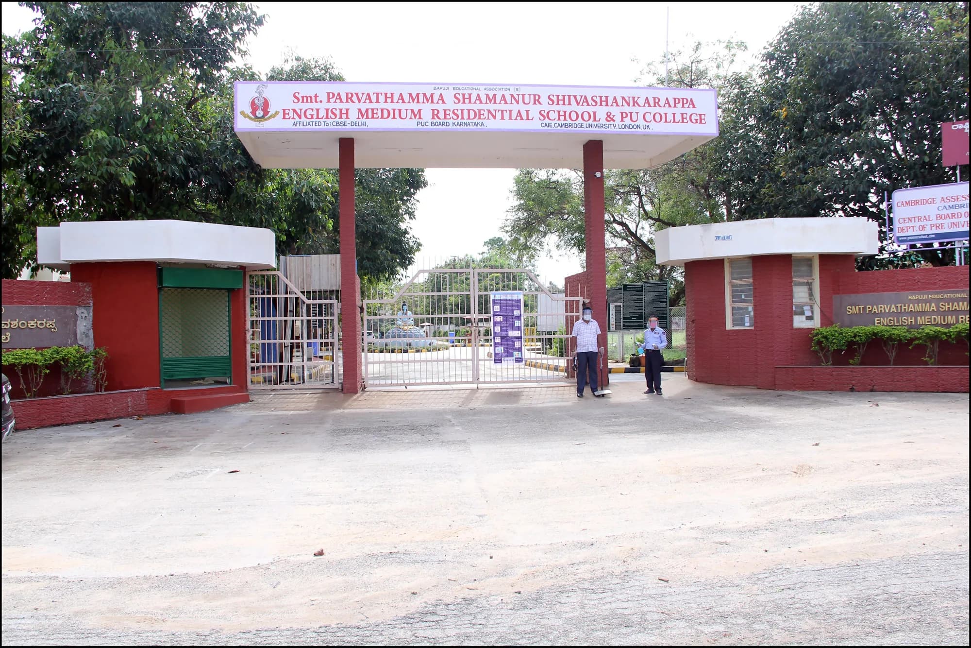 The main gate signboard at PSSEMR School, Davangere, listing its CBSE, PUC and Cambridge affiliations