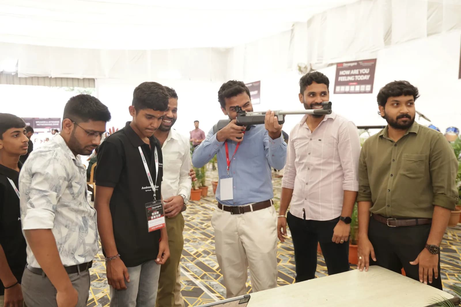 Delegates gathered around the shooting simulator in the Experience Zone