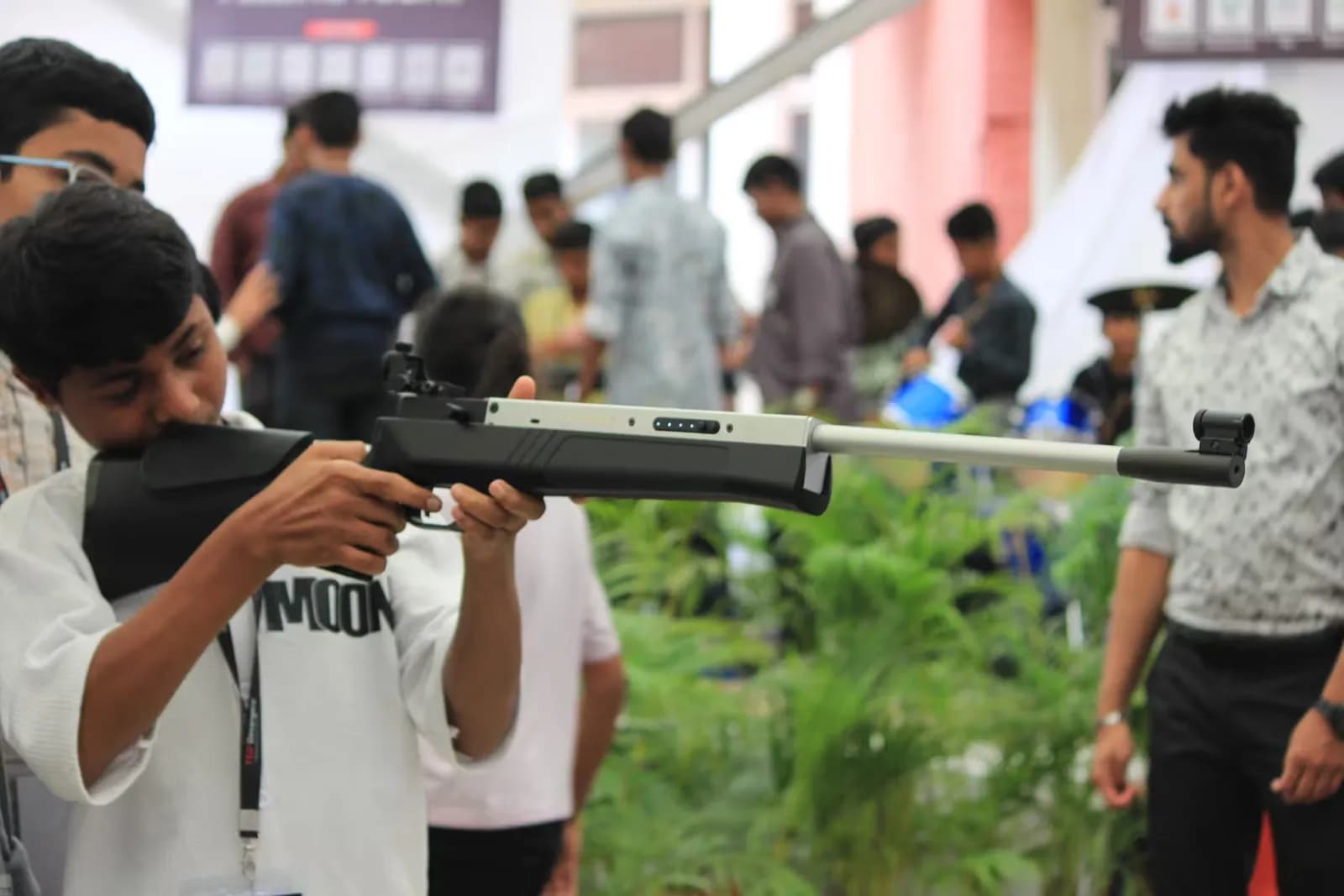 A delegate taking aim at the shooting simulation booth