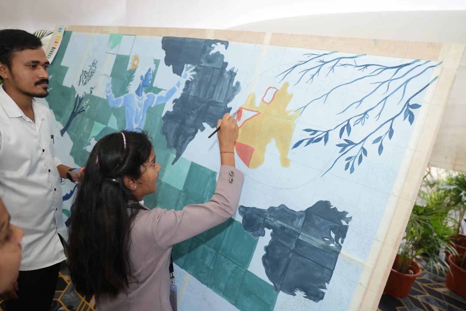 Students painting a mural at TEDxDavangere 2025