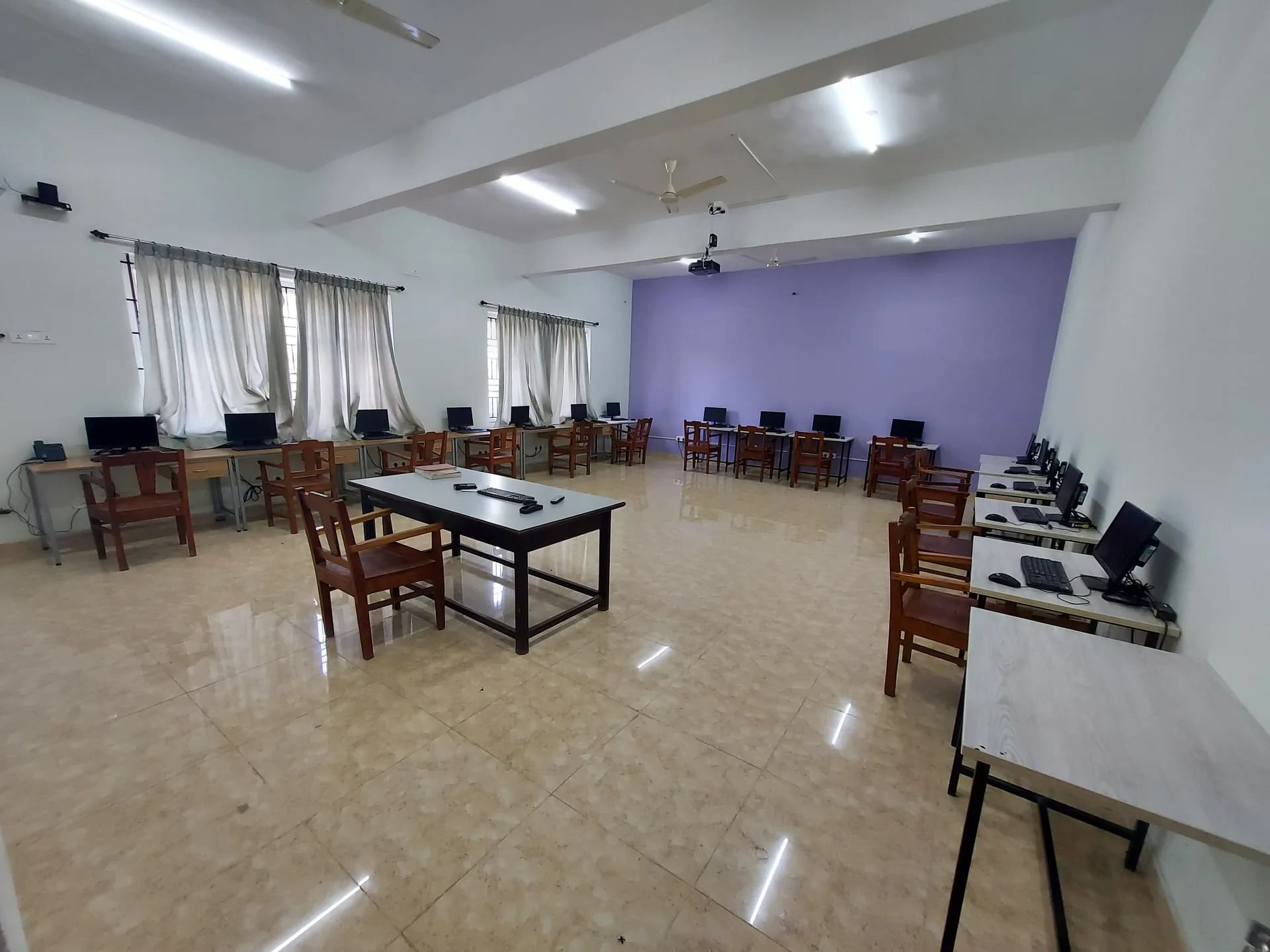 A computer laboratory at PSSEMR School, monitors on the benches and a projector at the front
