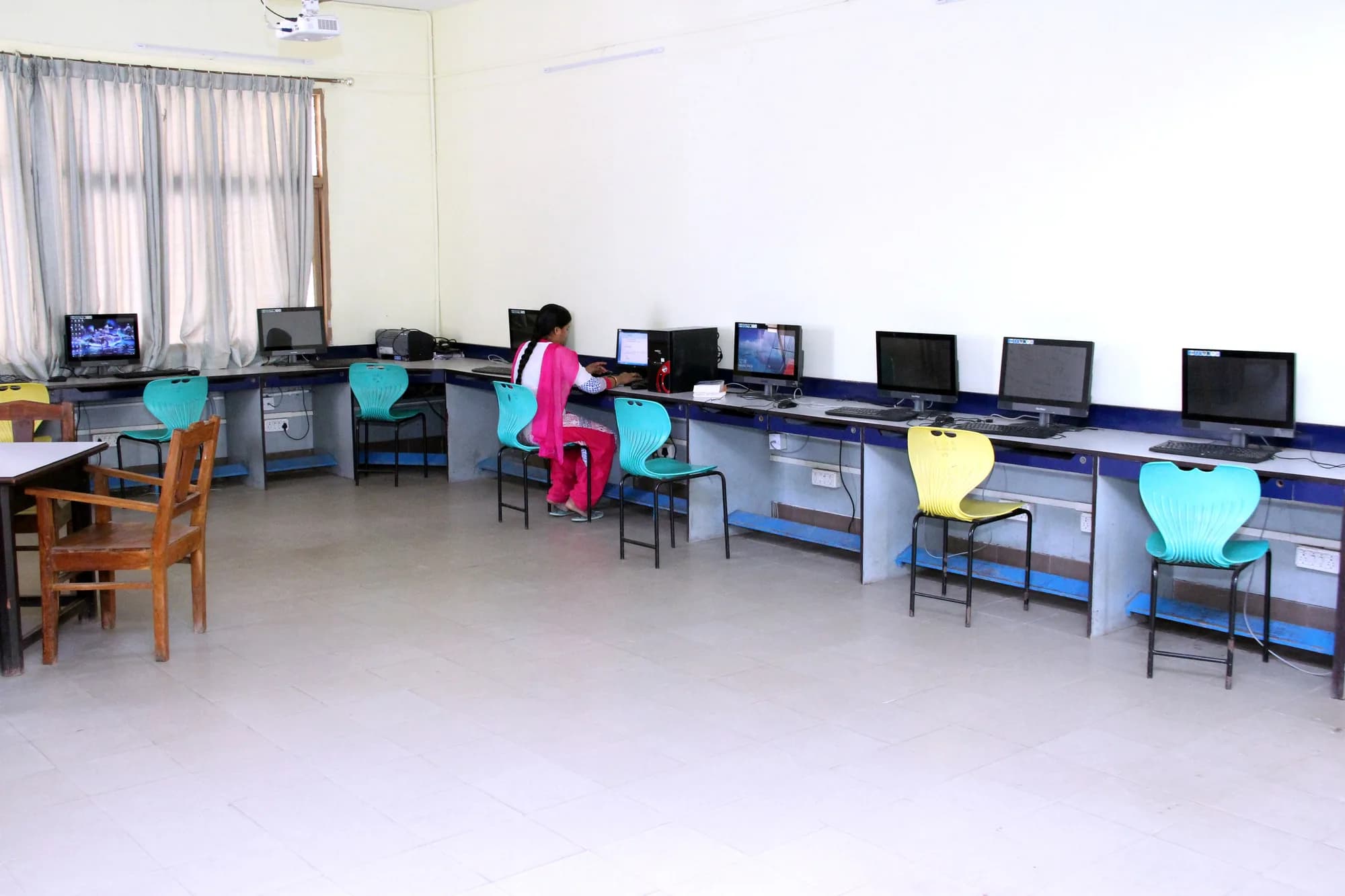 A computer room in use at PSSEMR School, monitors along the bench