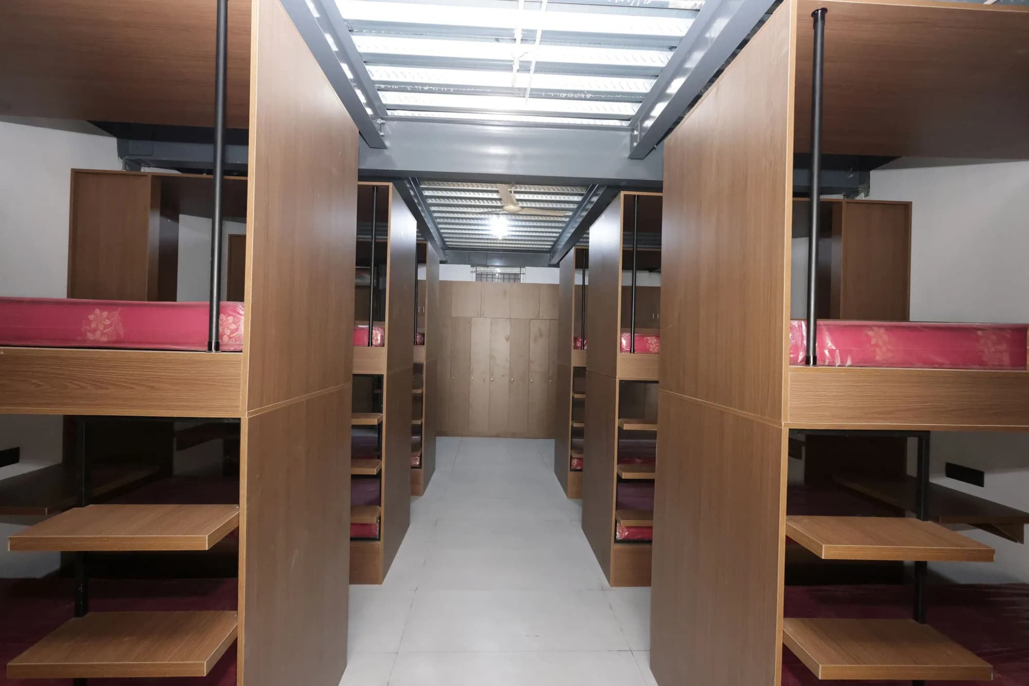 Boarding dormitory at PSSEMR School with bunk cubicles and fold-down study desks