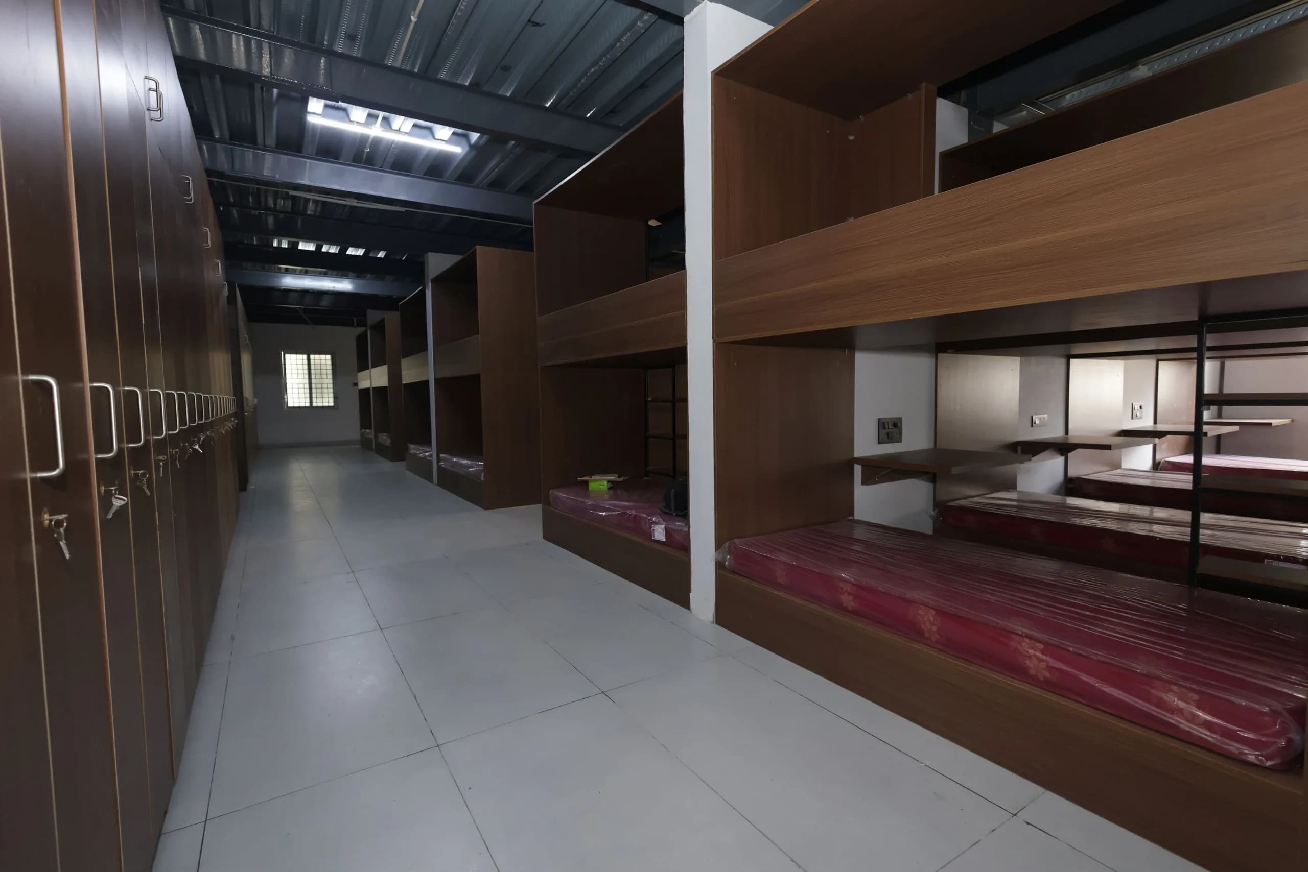 A boarding dormitory at PSSEMR School, lockers and bunk beds made up