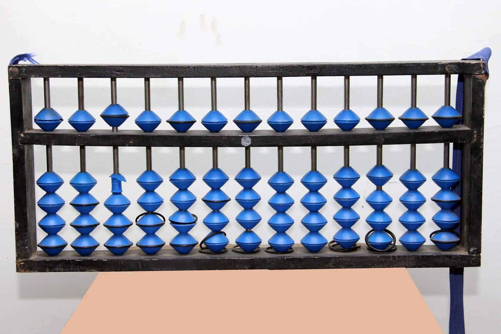 Large blue-bead abacus mounted in a black frame