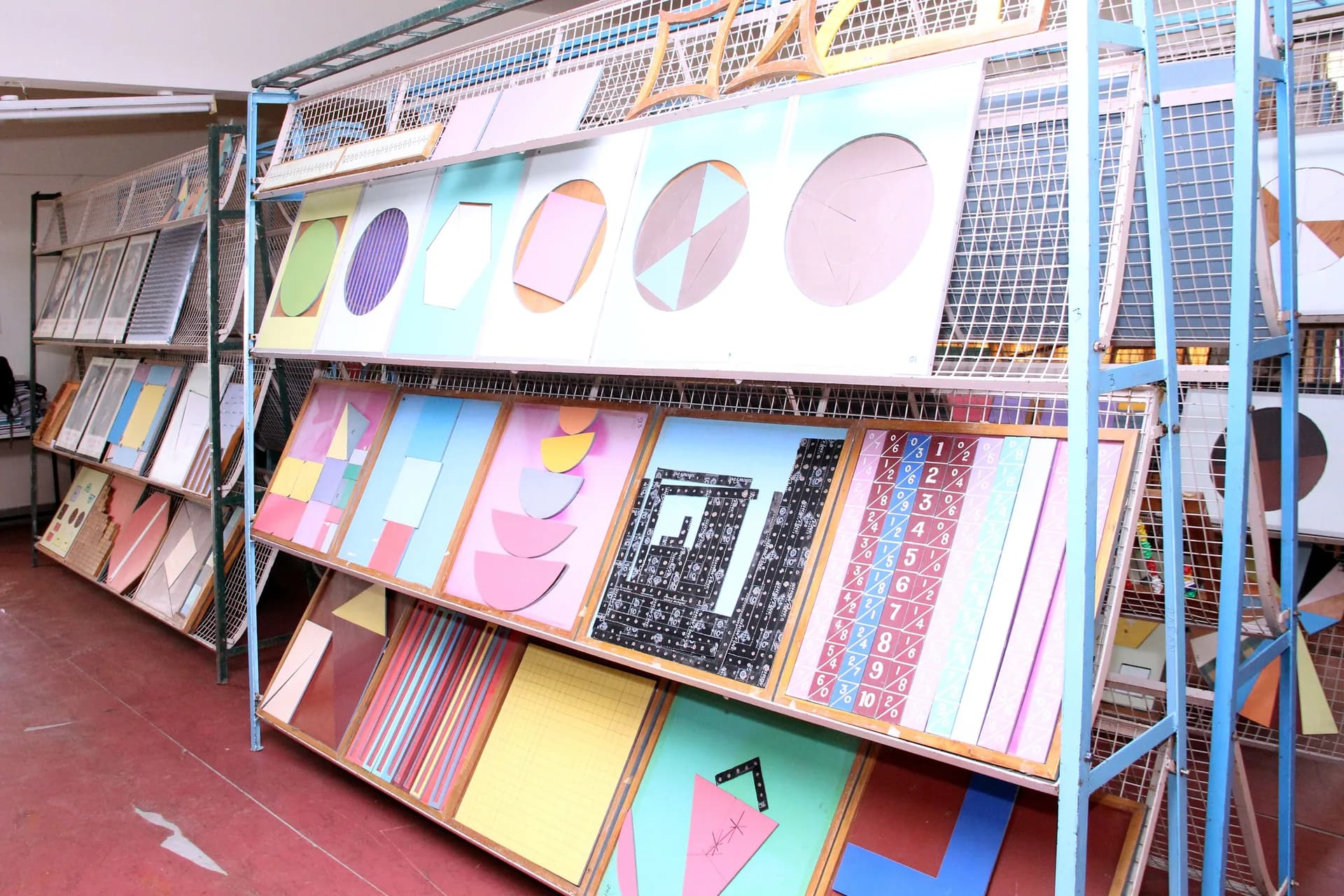 Rack of hand-made geometry charts, fraction wheels and number aids