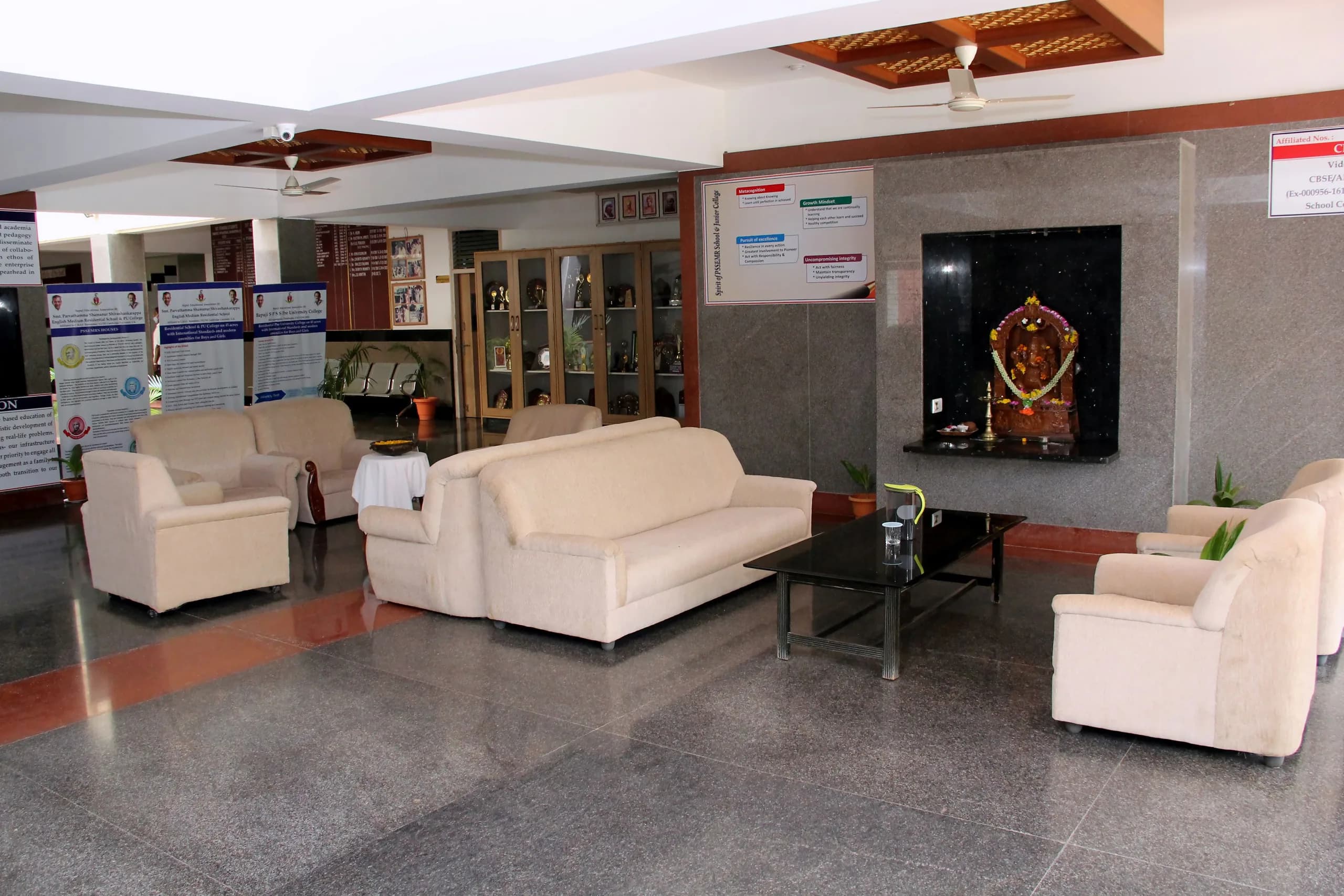 Reception corridor at PSSEMR School, with display boards and waiting seating