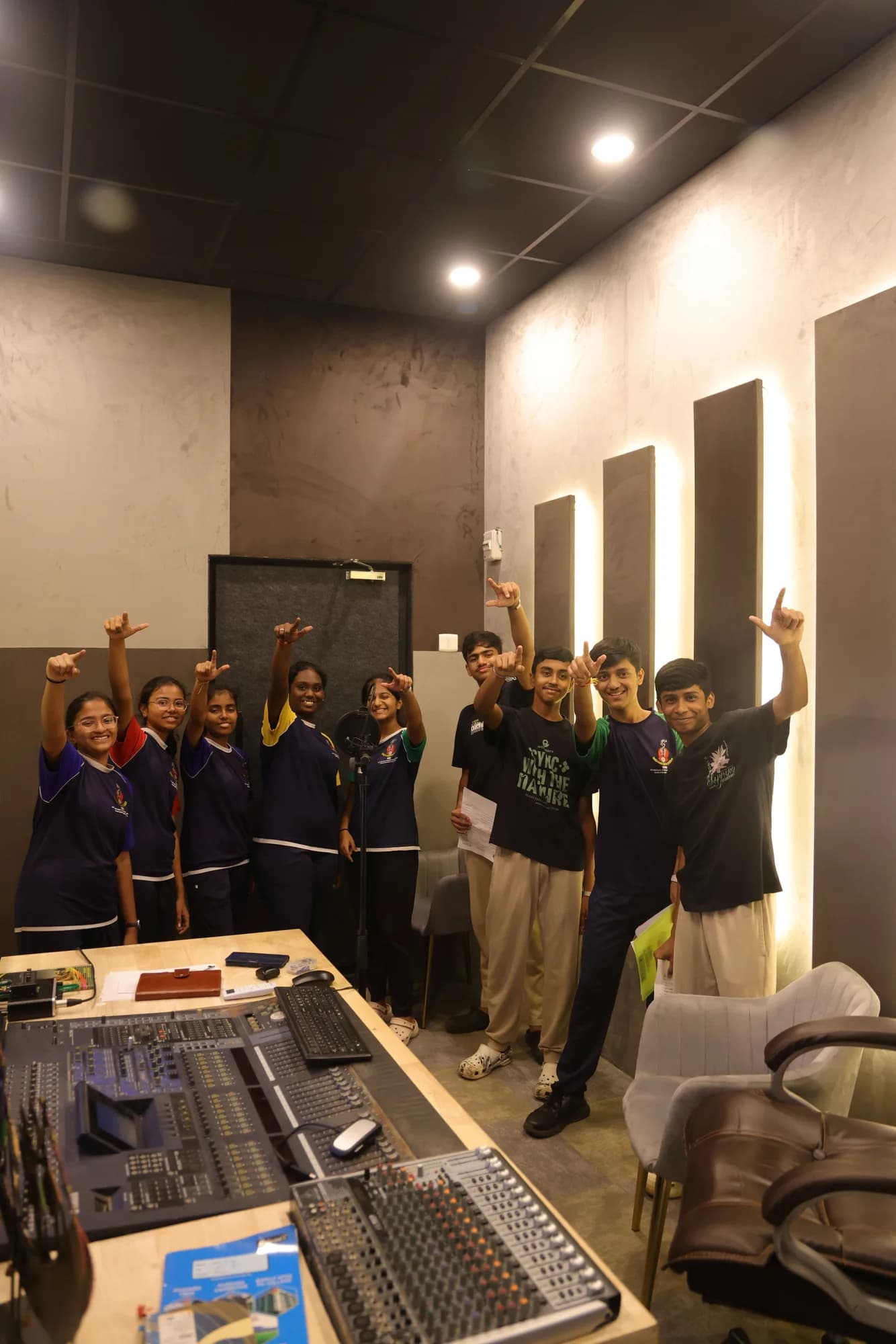 Students behind a mixing console in an acoustically panelled studio at PSSEMR School