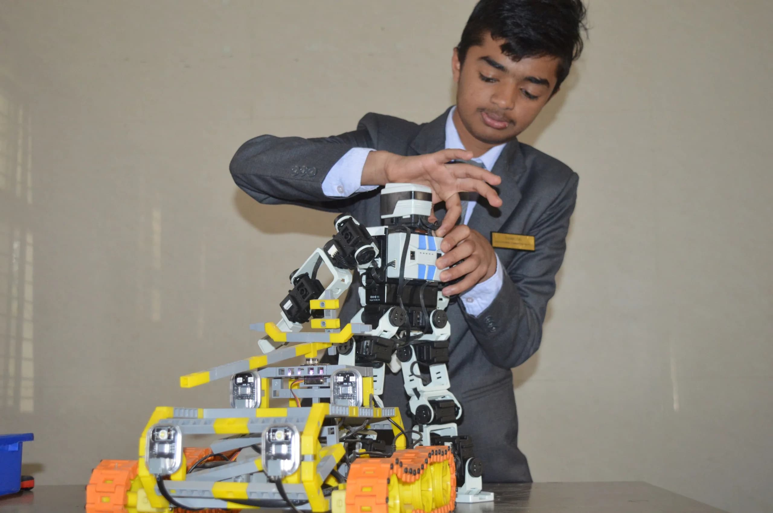 A student working with a humanoid robot in the PSSEMR School robotics laboratory